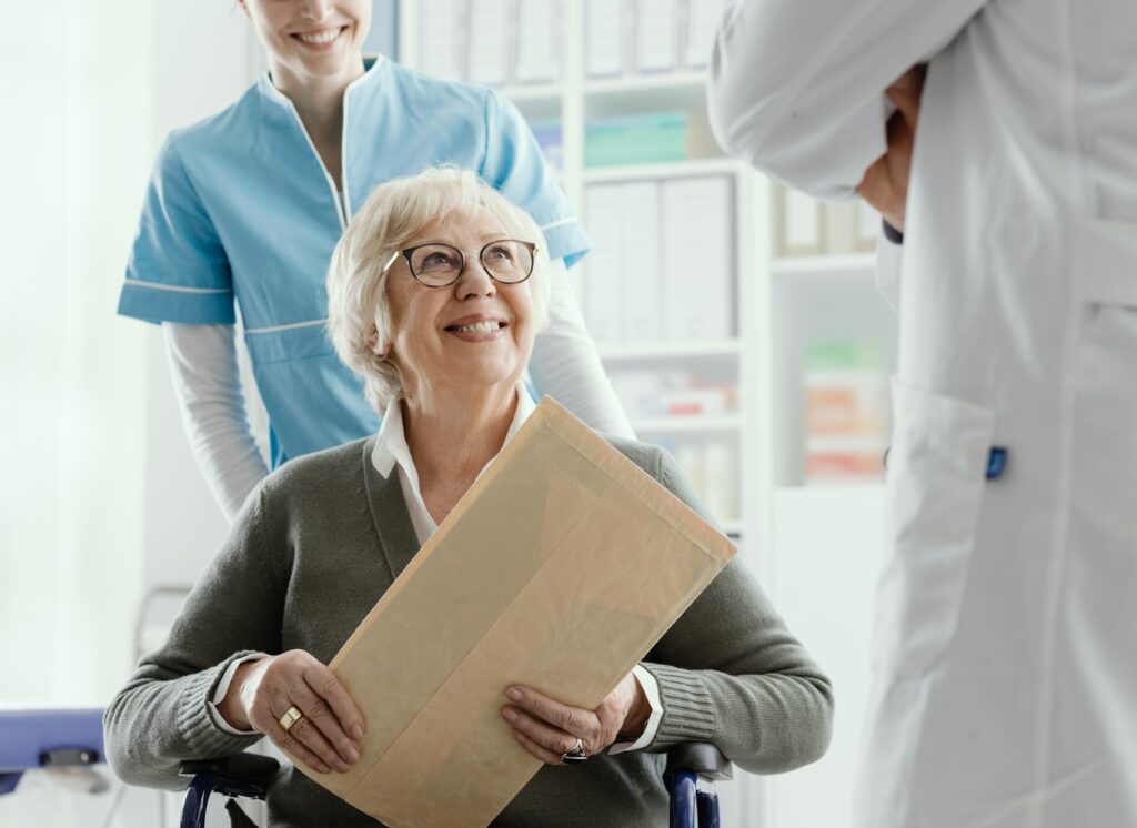Senior patient on wheelchair with medical staff